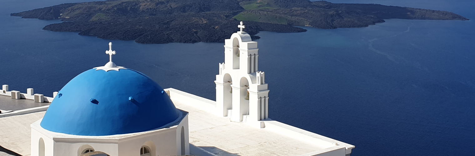 A blue-domed church one sees during the accessible Santorini tour by Santorini Experts