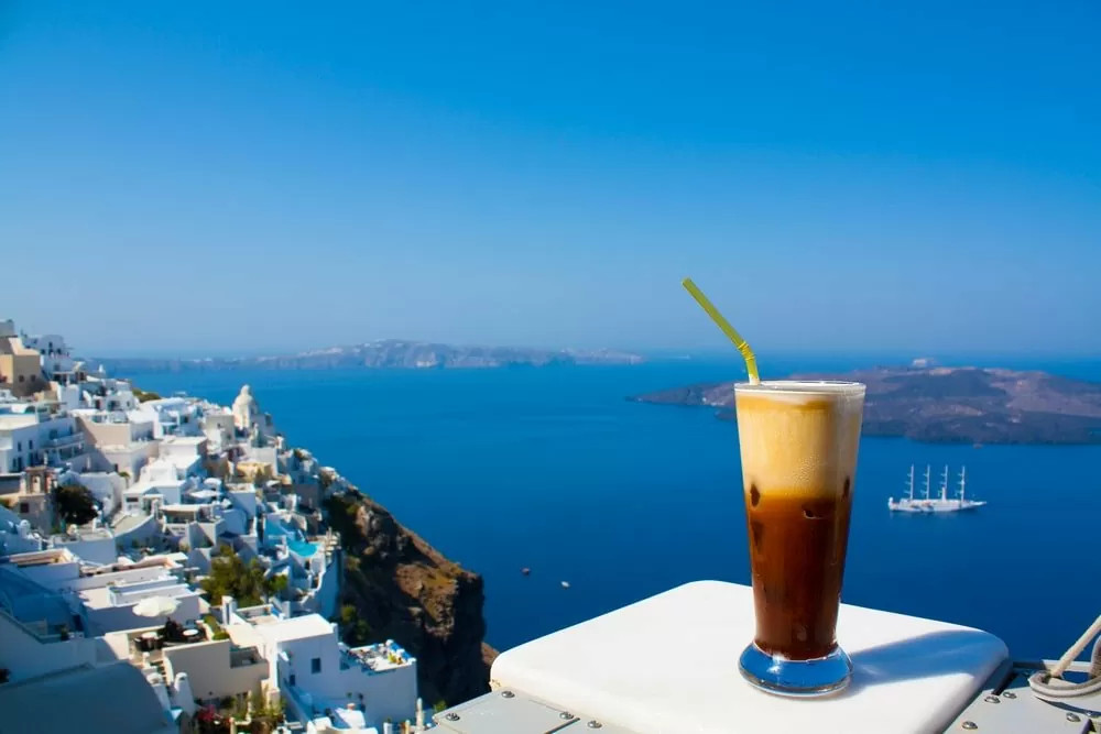Virtual Tours of Santorini kick start is a Greek frappe with Caldera view