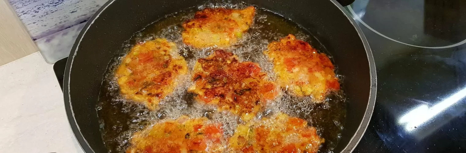 Croquettes being fried in a pan