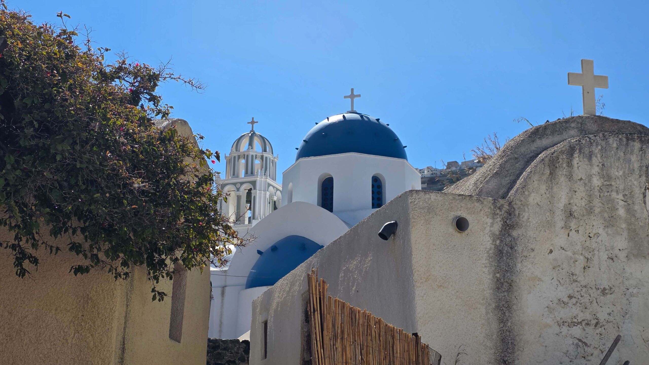 A whitewashed blue-domed church in Mesa Gonia, Santorini