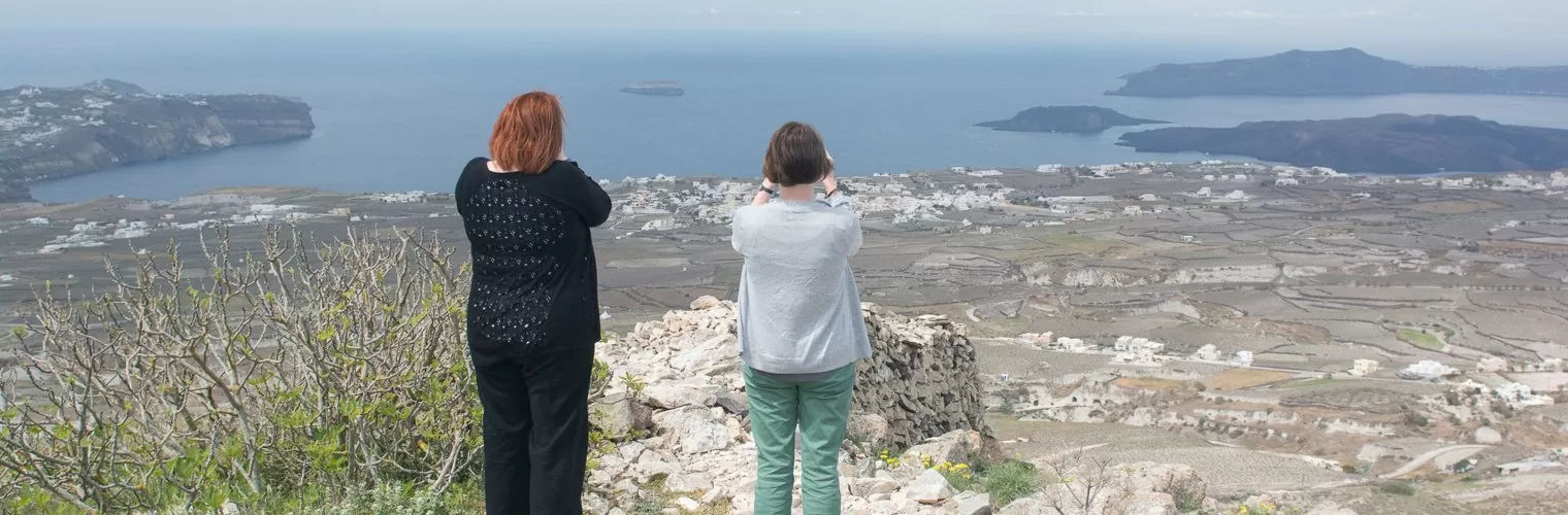 2 women shooting the Santorini panorama during a Santorini photography tour
