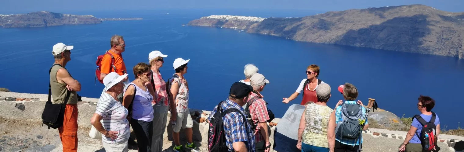 Tour guide talks to the tourists during a Santorini small group tour