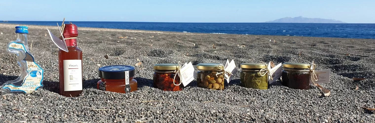 Santorini souvenirs aligned on the beach sand