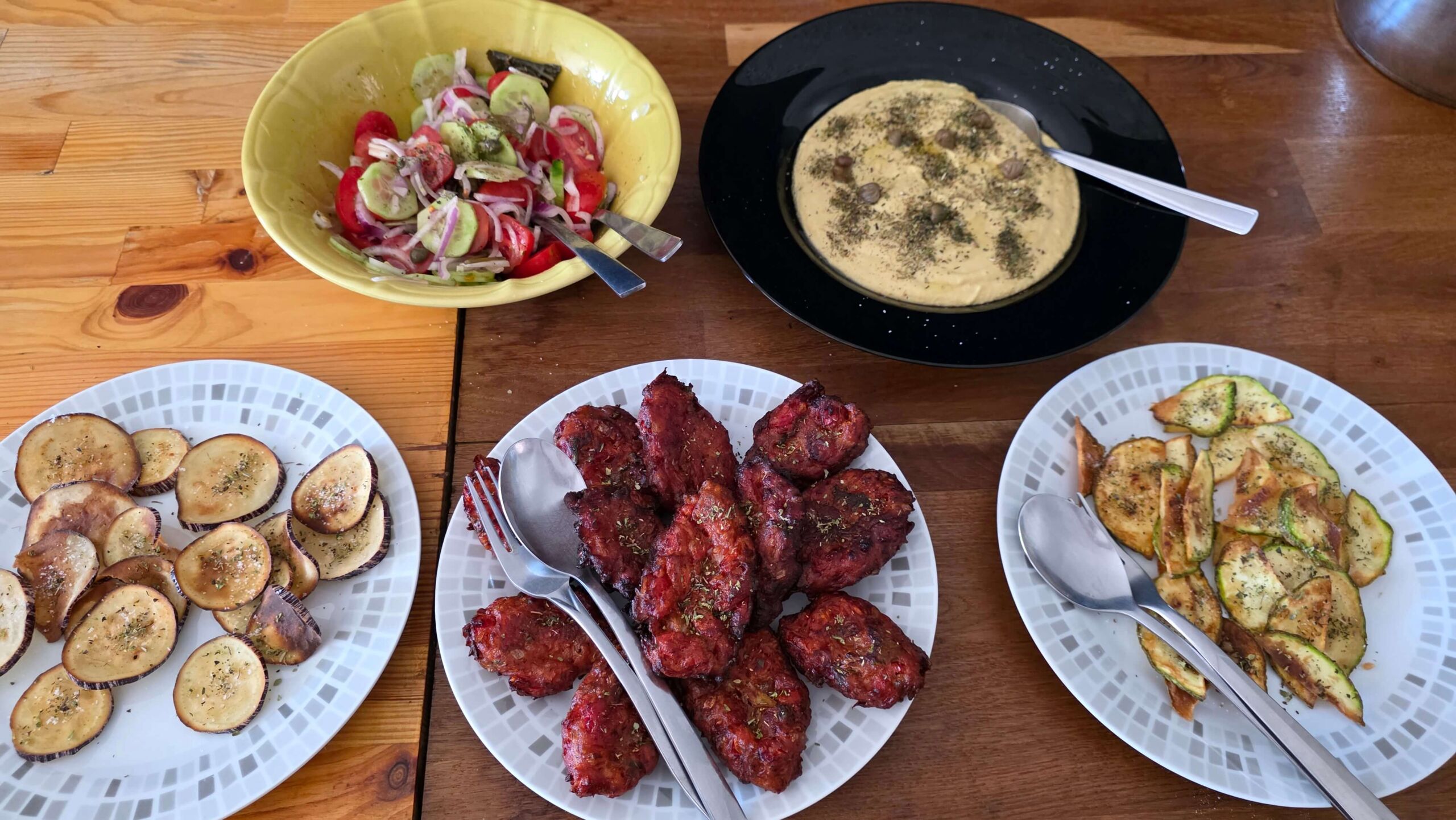 Local Santorini dishes served side by side on a wooden table