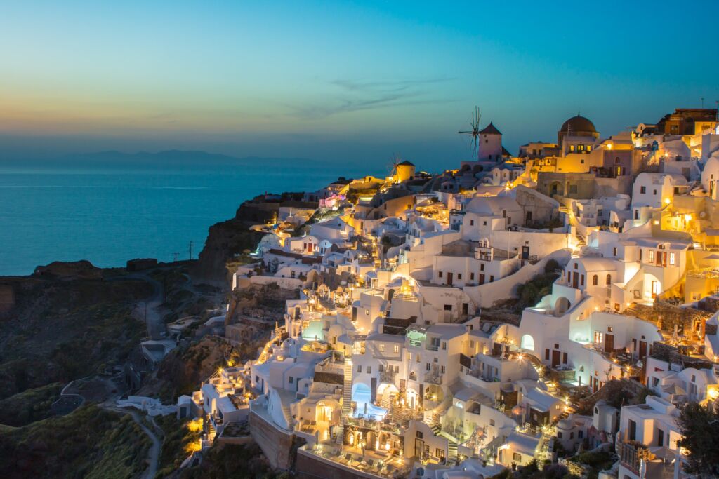 Lit whitewashed houses are a sight to behold that will make you stop wondering "is Santorini worth it"