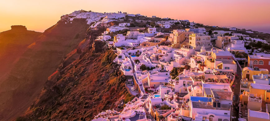 Whitewashed buildings in Santorini caldera during the golden hour